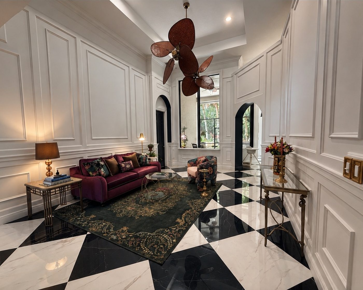 Living room with panelled walls, arched openings and a black-and-white marble checkerboard floor, furnished with a deep magenta sofa and a dark patterned rug.